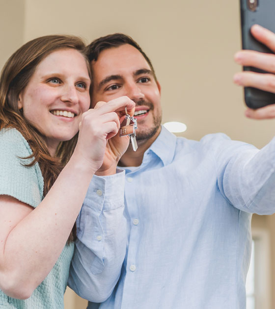 Couple taking selfie after accepted offer on home.